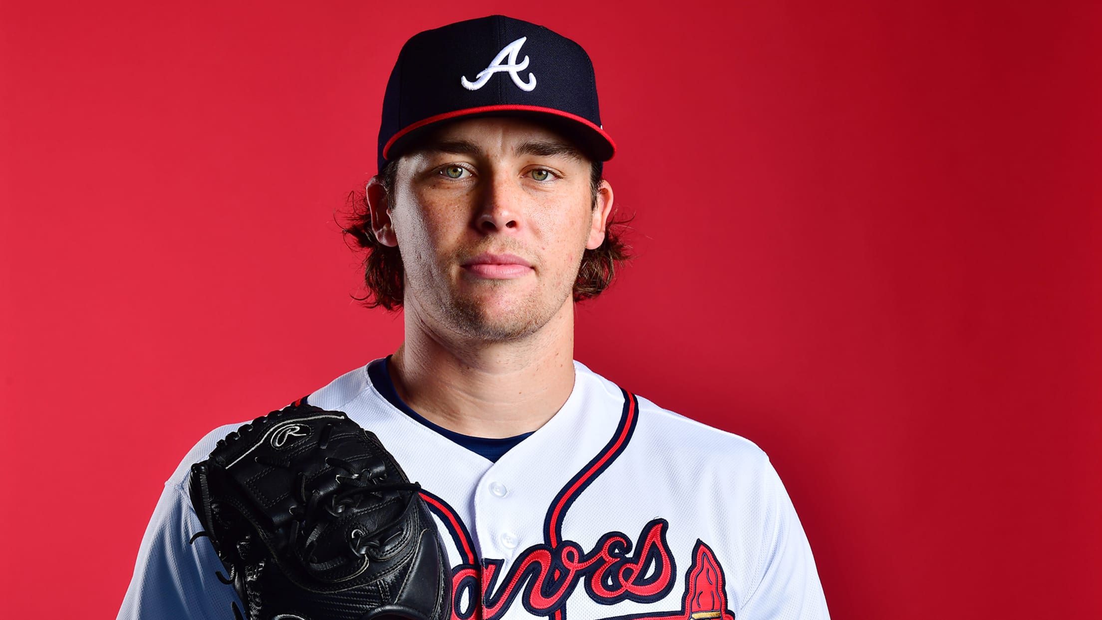 A portrait of a Braves player in front of a red background