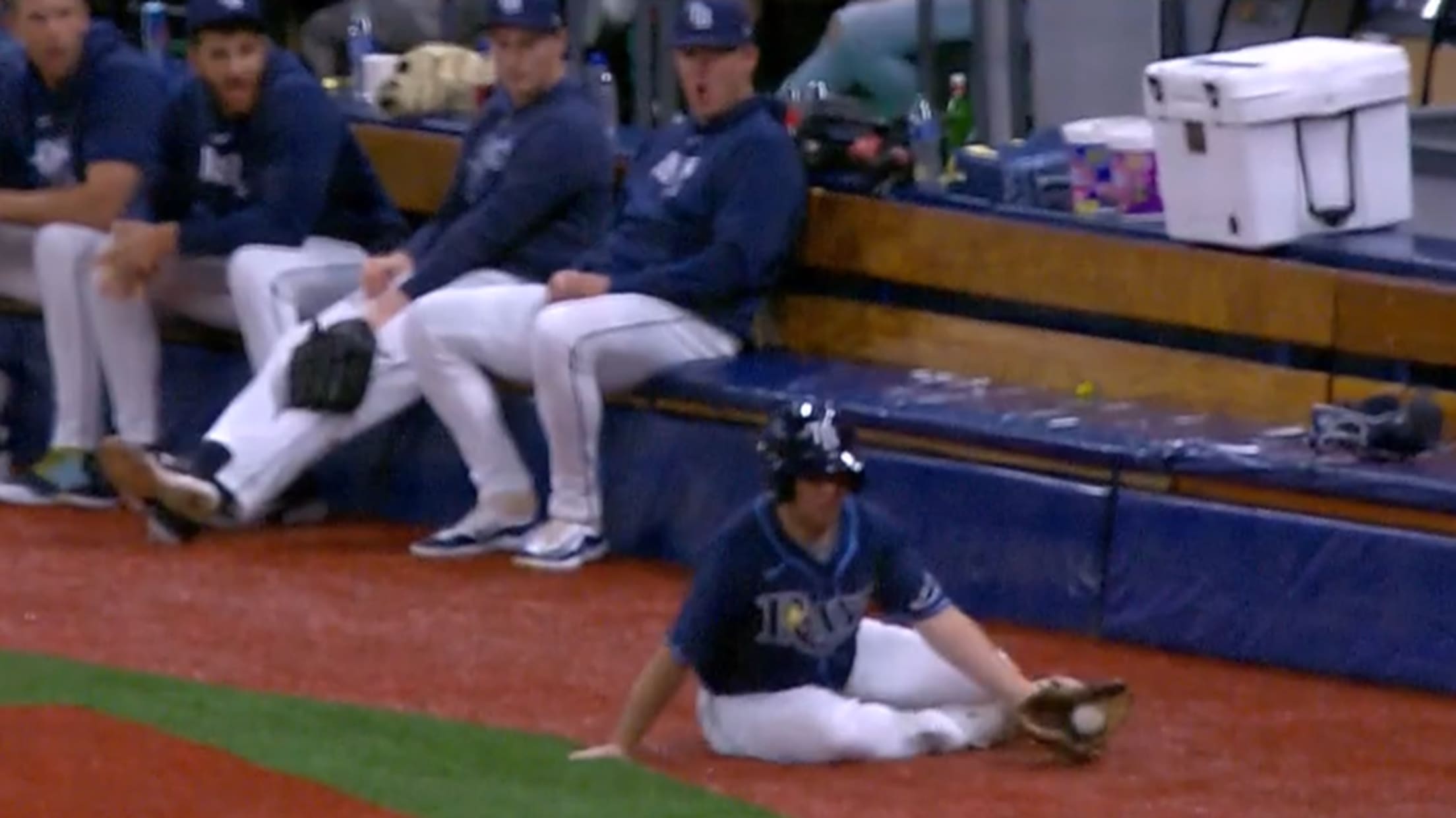 A Rays ballboy snags a grounder from the ground
