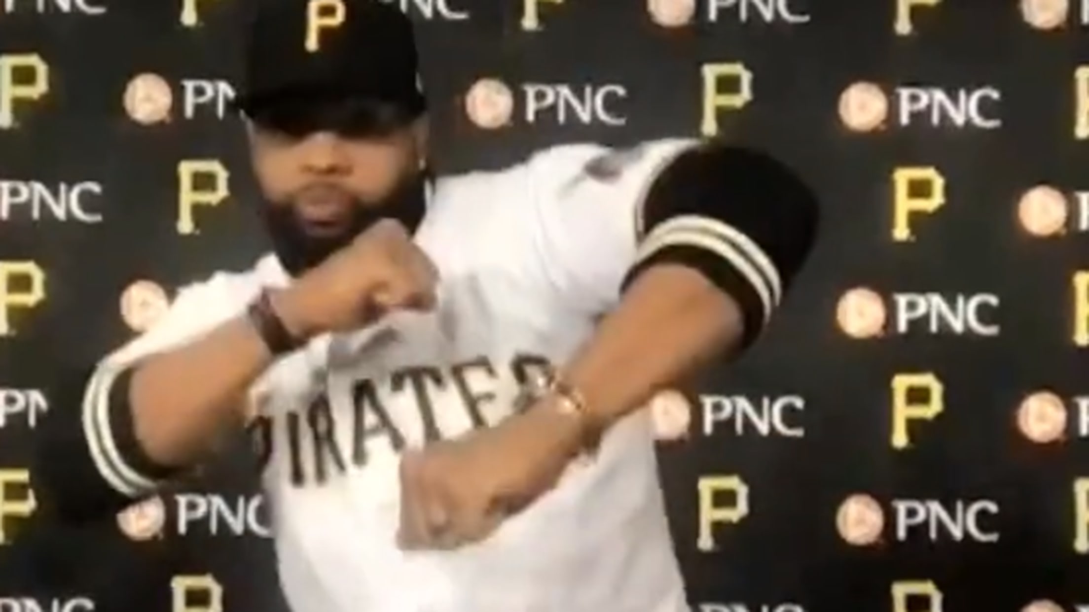 A screengrab from a video showing Carlos Santana dancing in a Pirates uniform