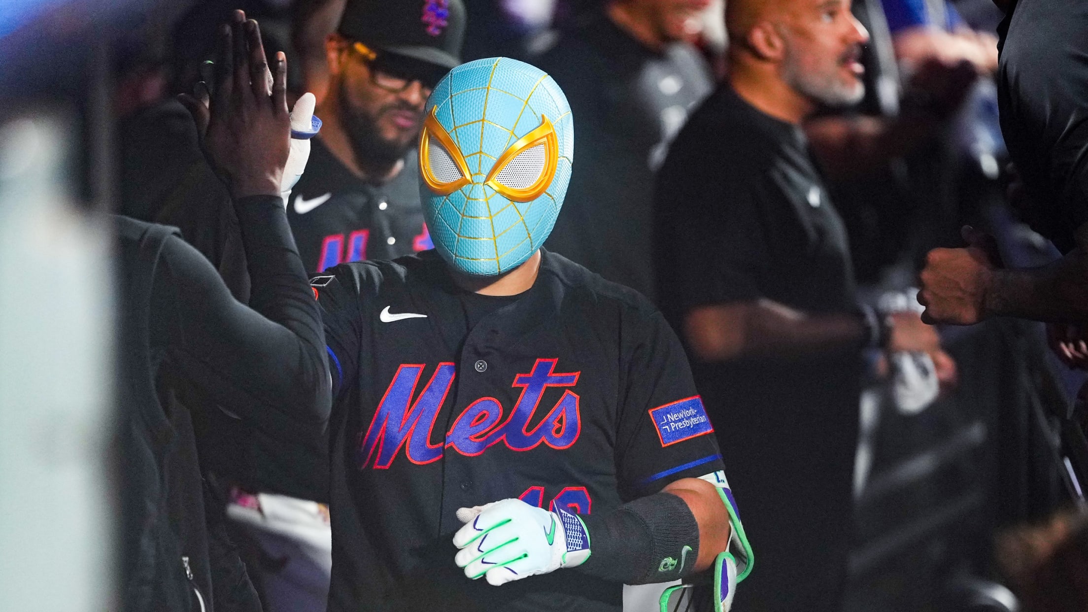 Bo Bichette wears a light-blue Spider-Man mask in the dugout