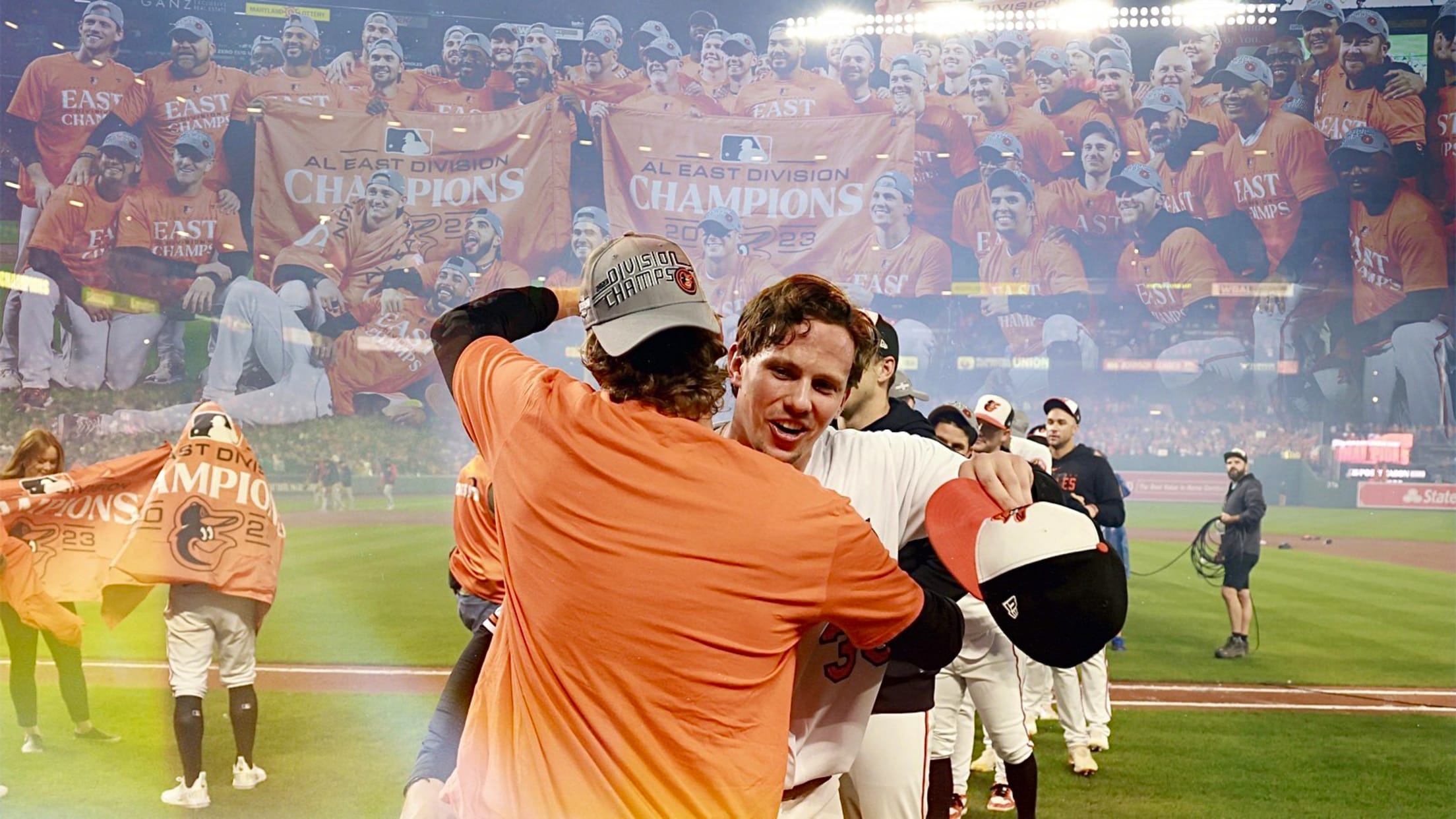 Adley Rutschman hugs a teammate as the Orioles celebrate on the field