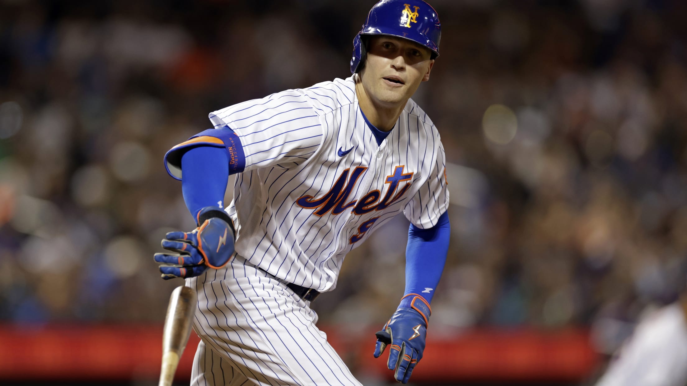 Brandon Nimmo drops his bat as he runs to first base