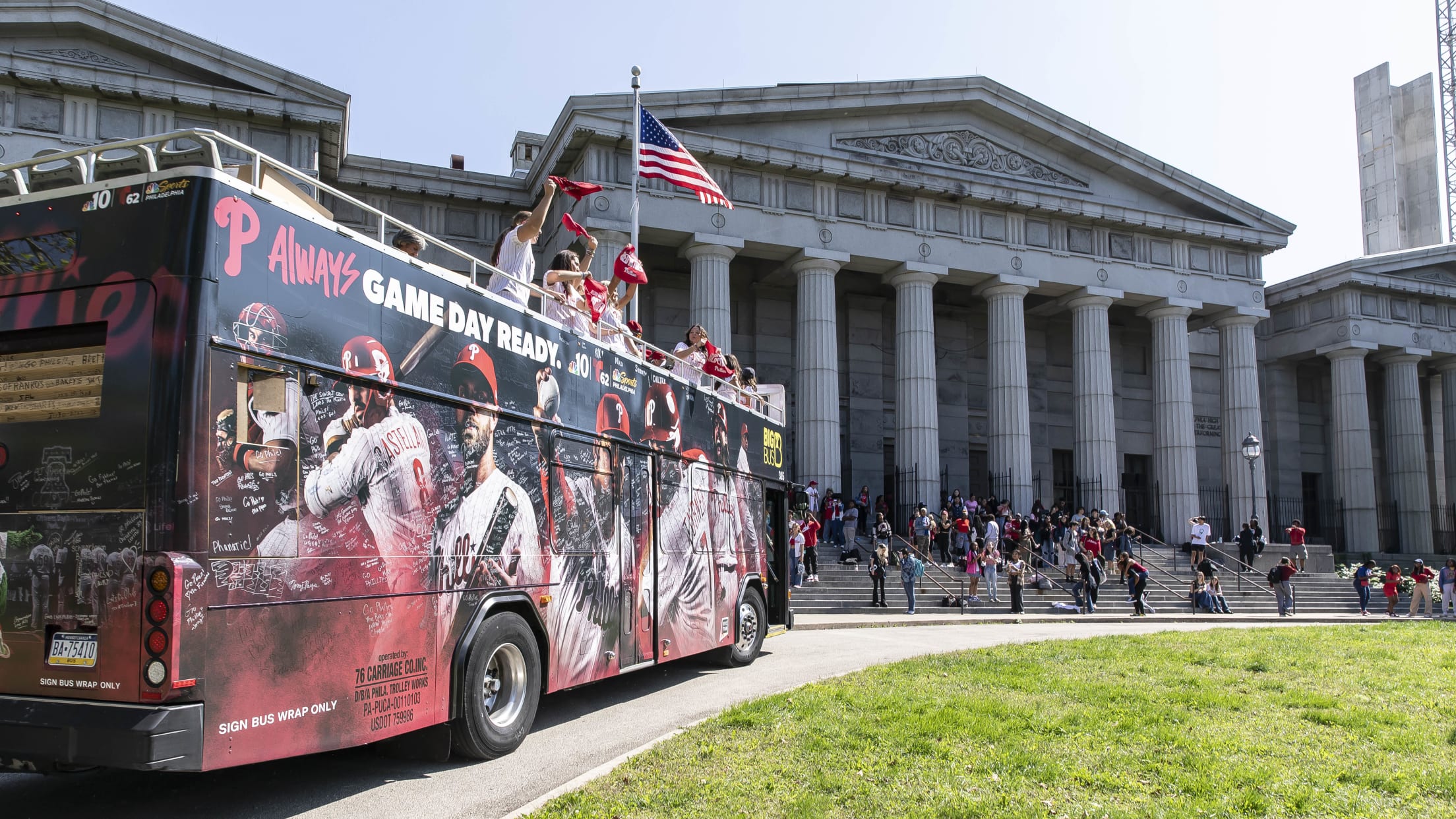 Phillies fans celebrate during Rally for Red October bus tour