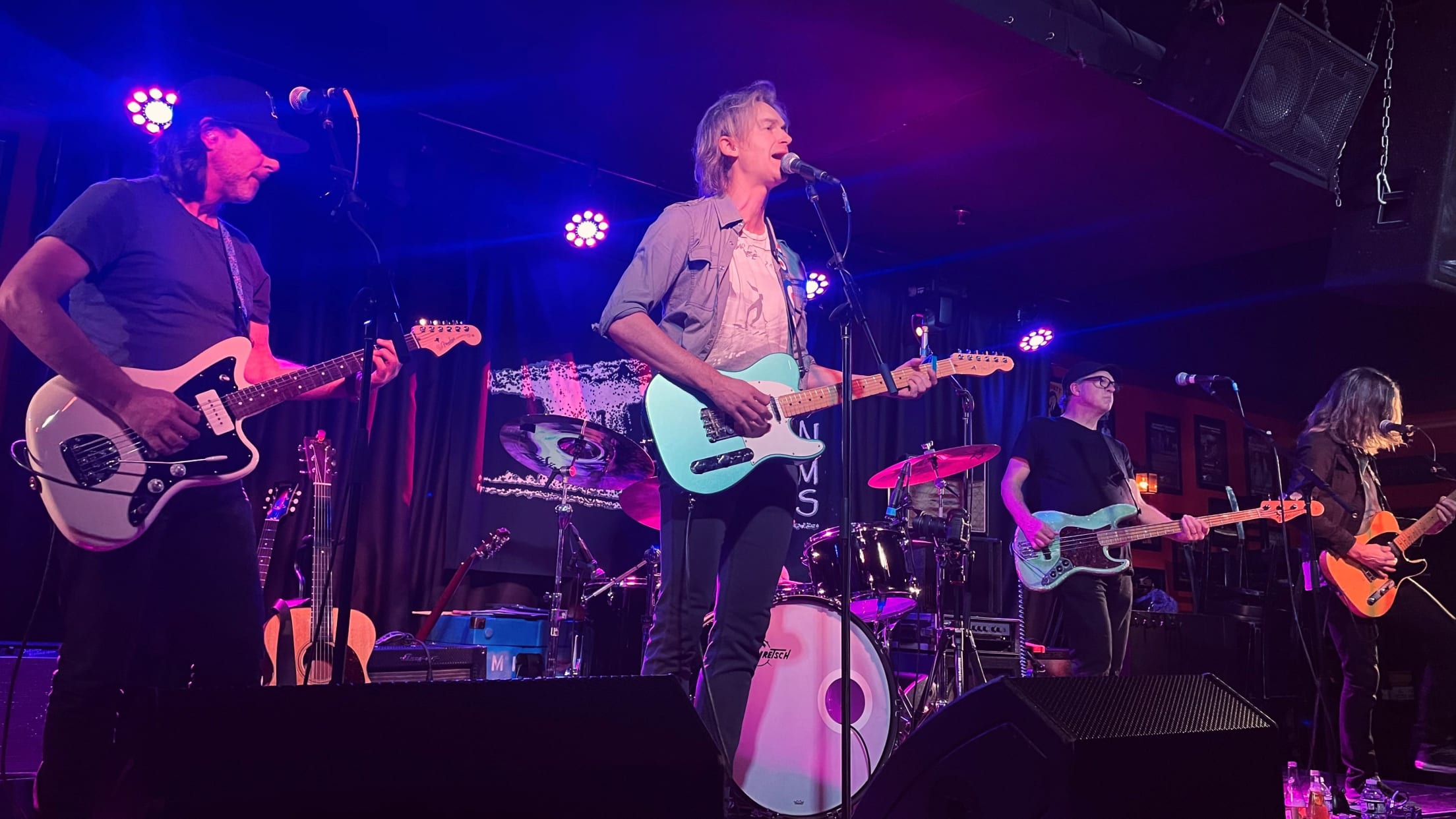 A rock band on stage at a club