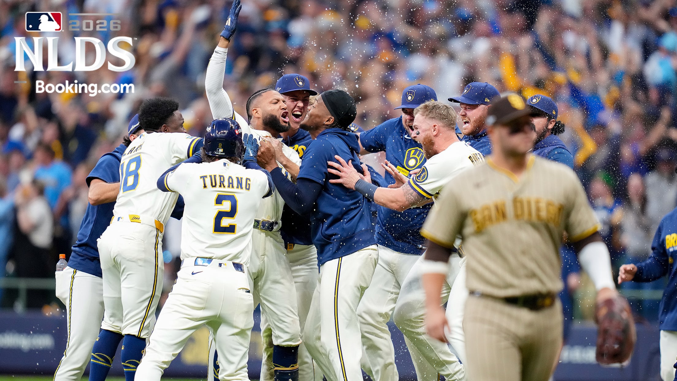 The Brewers celebrate around Jackson Chourio as a Padres player walks off the field