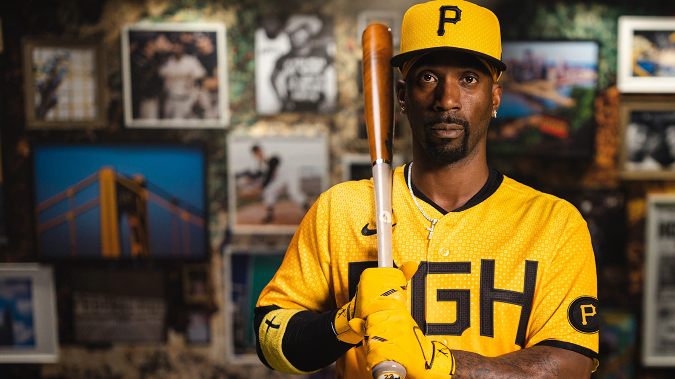 Andrew McCutchen poses in the Pirates' gold City Connect cap and jersey