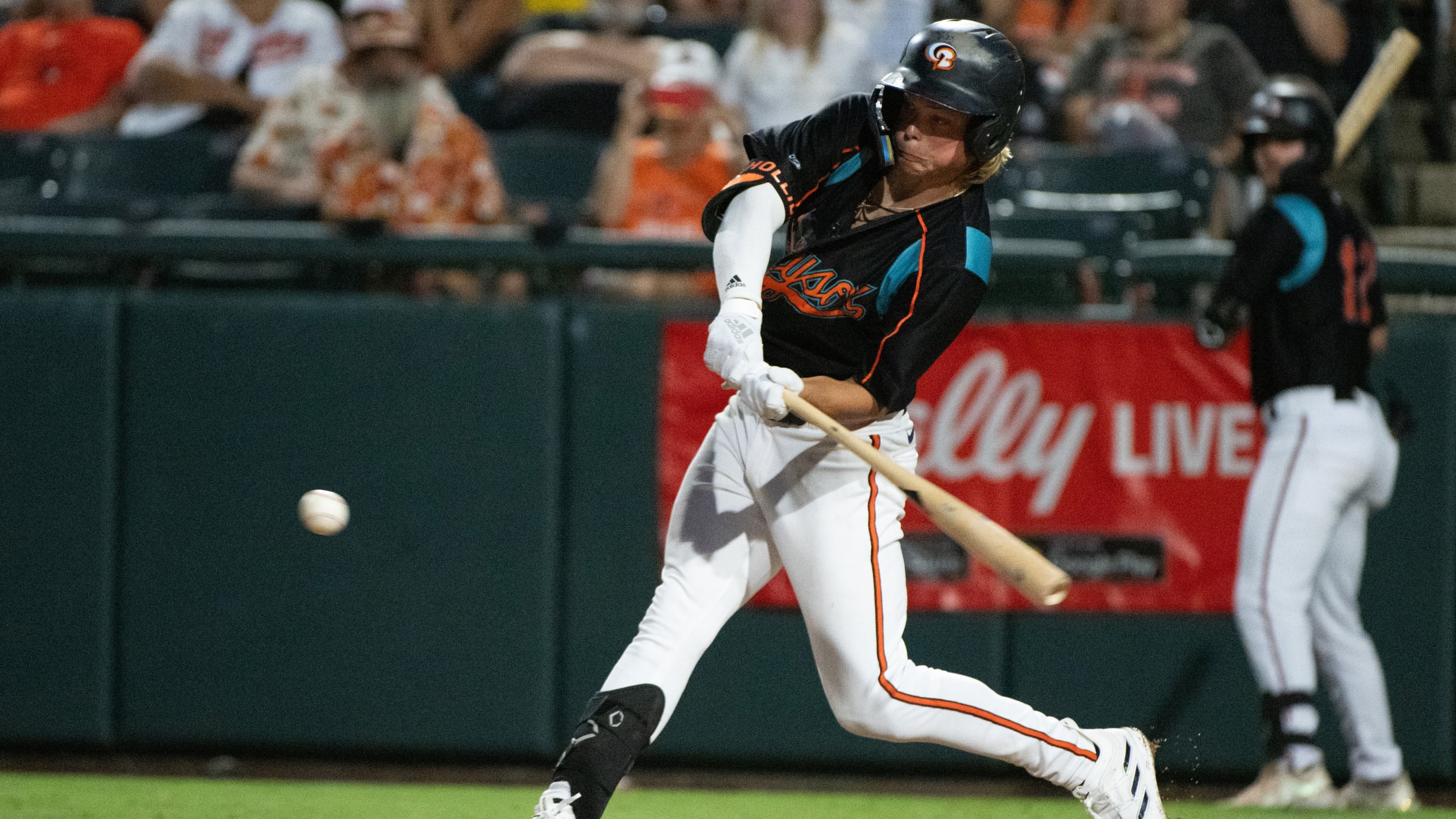 Jackson Holliday swings at a pitch