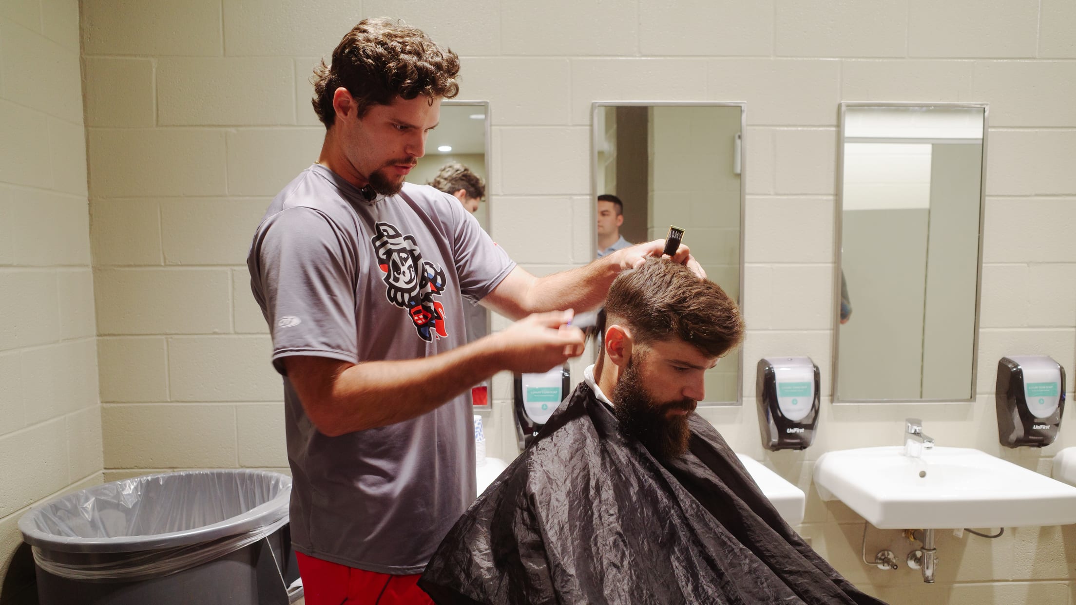 Pitcher Victor Mederos cuts his teammates' hair