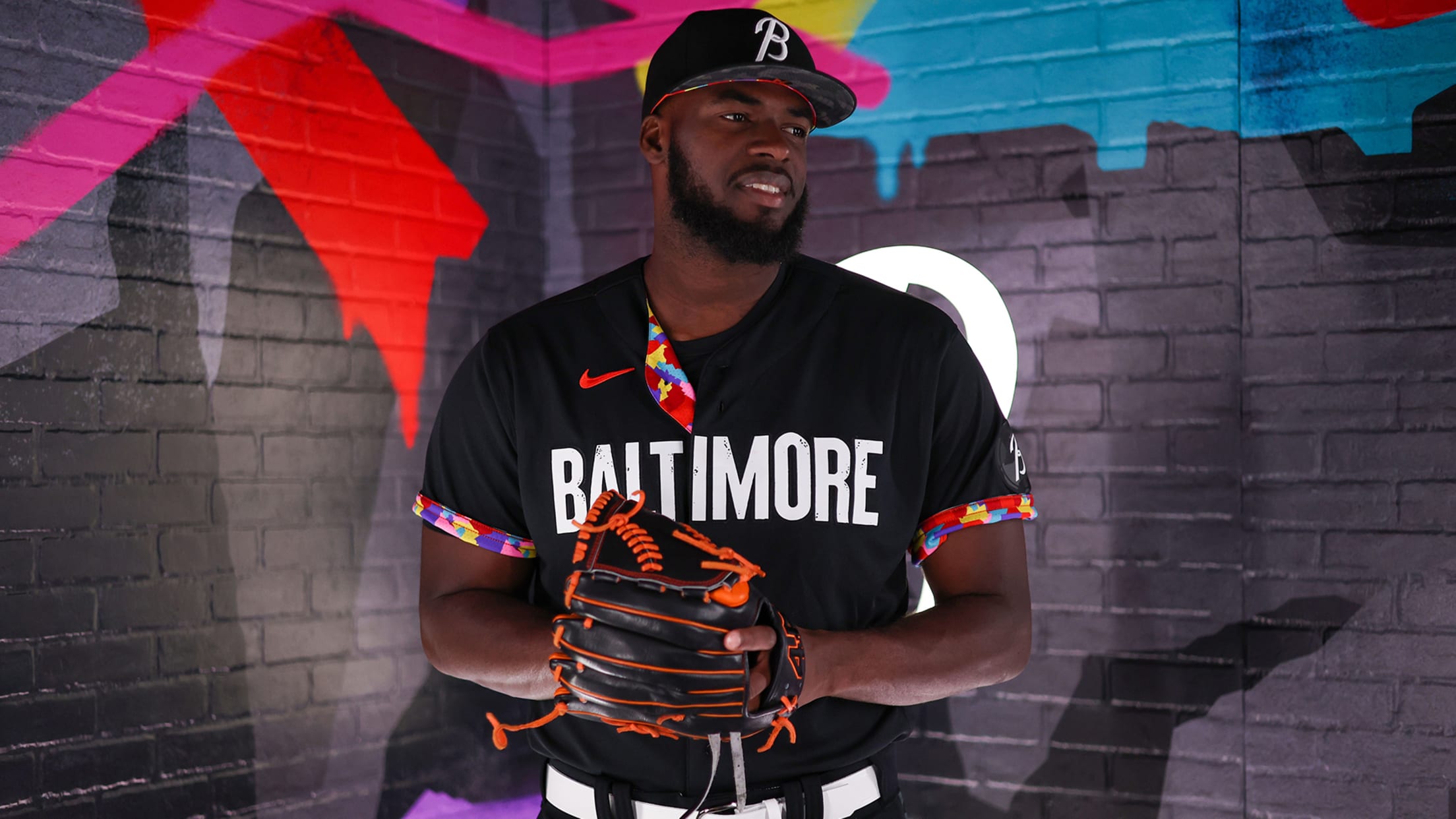 Félix Bautista poses in a black uniform that reads ''BALTIMORE'' in white letters