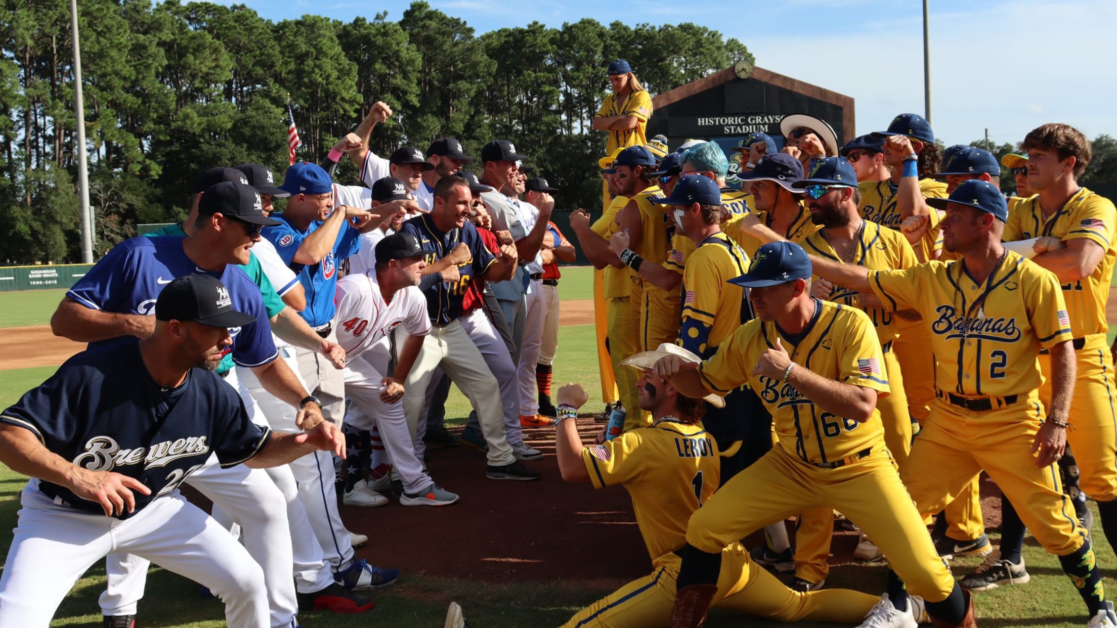 Former MLB players in their team uniforms square off against the Savannah Bananas in their yellow uniforms