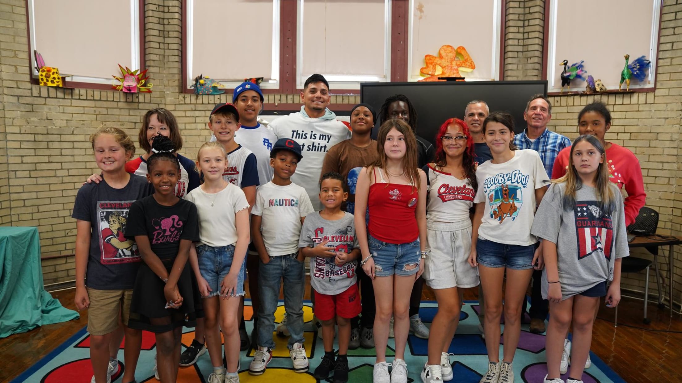 Guardians second baseman Andrés Giménez poses with elementary-school students