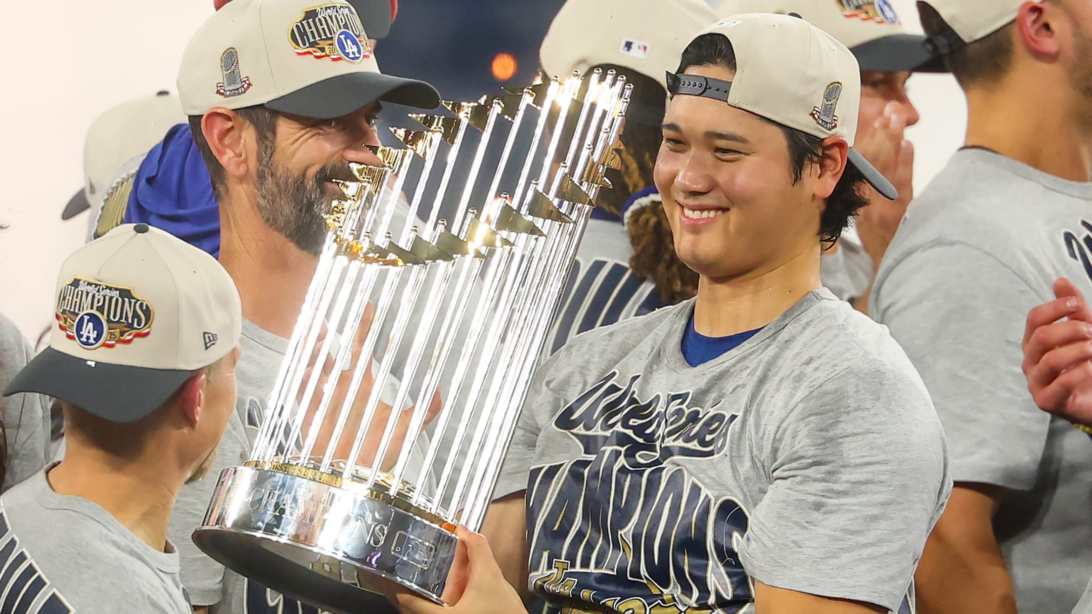 Shohei Ohtani smiles while holding the championship trophy