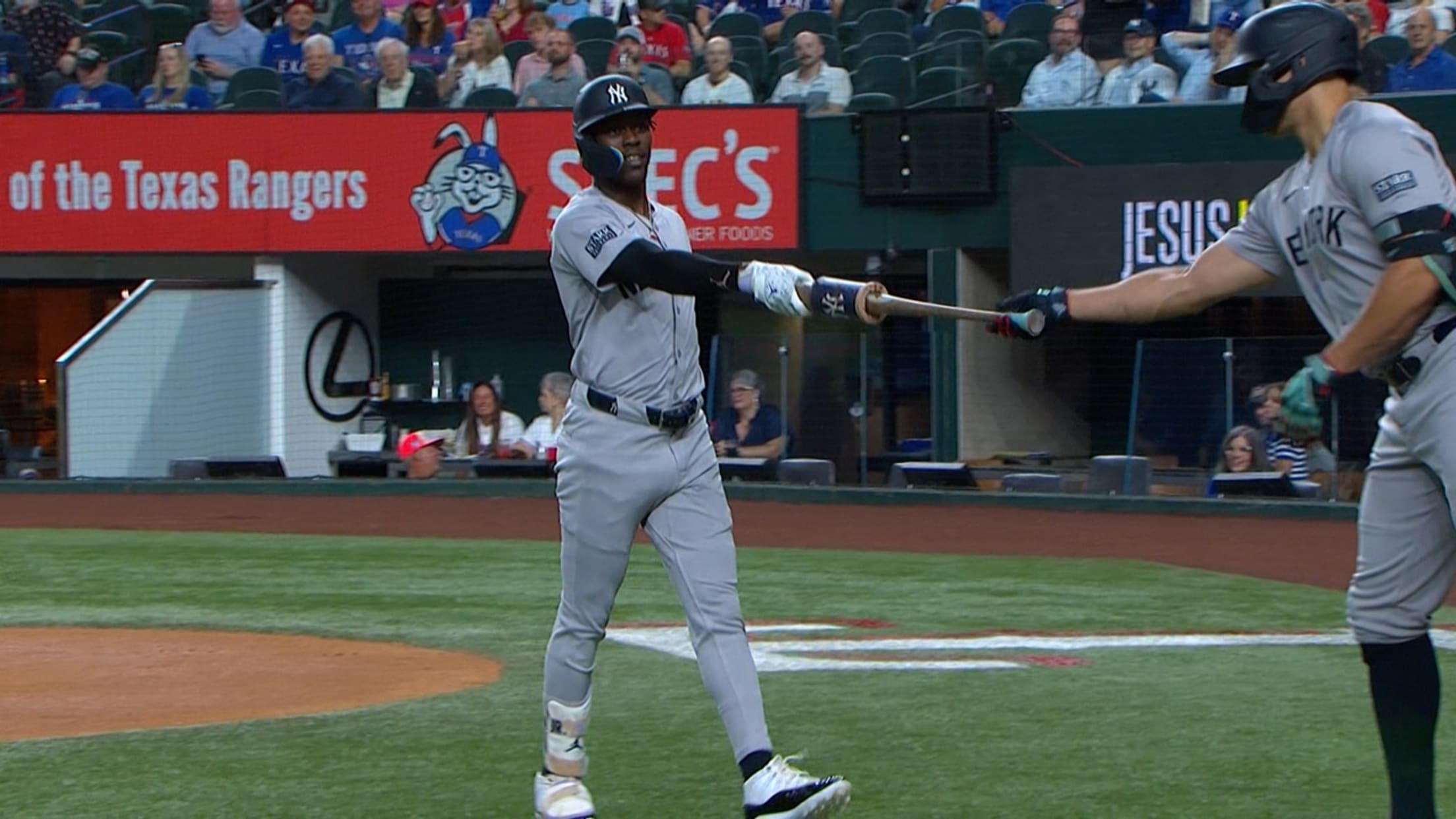 Jazz Chisholm Jr. hands his bat to Giancarlo Stanton