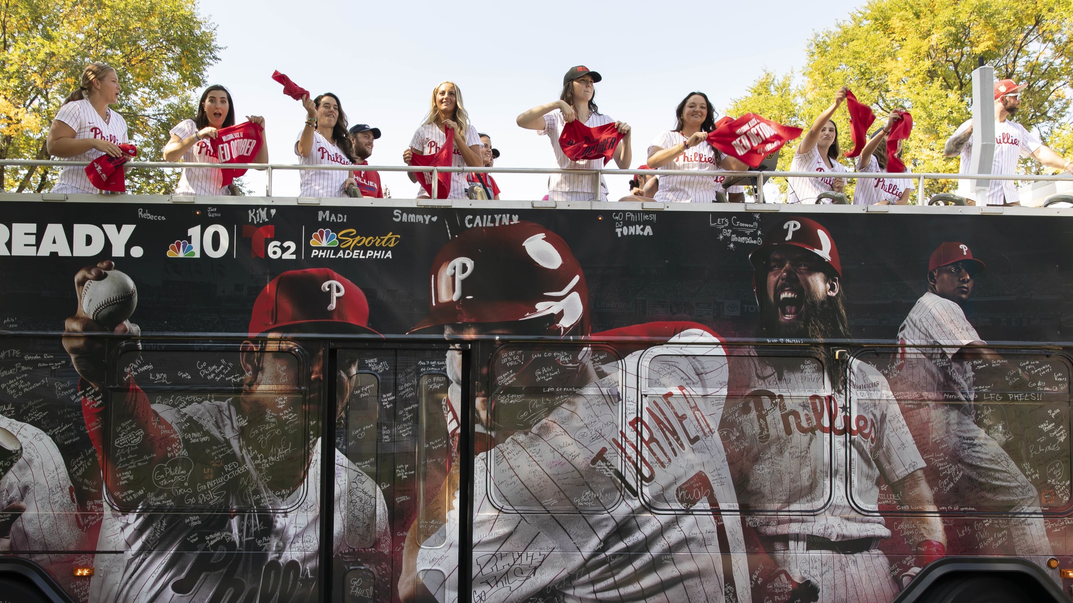 Phillies fans celebrate during Rally for Red October bus tour