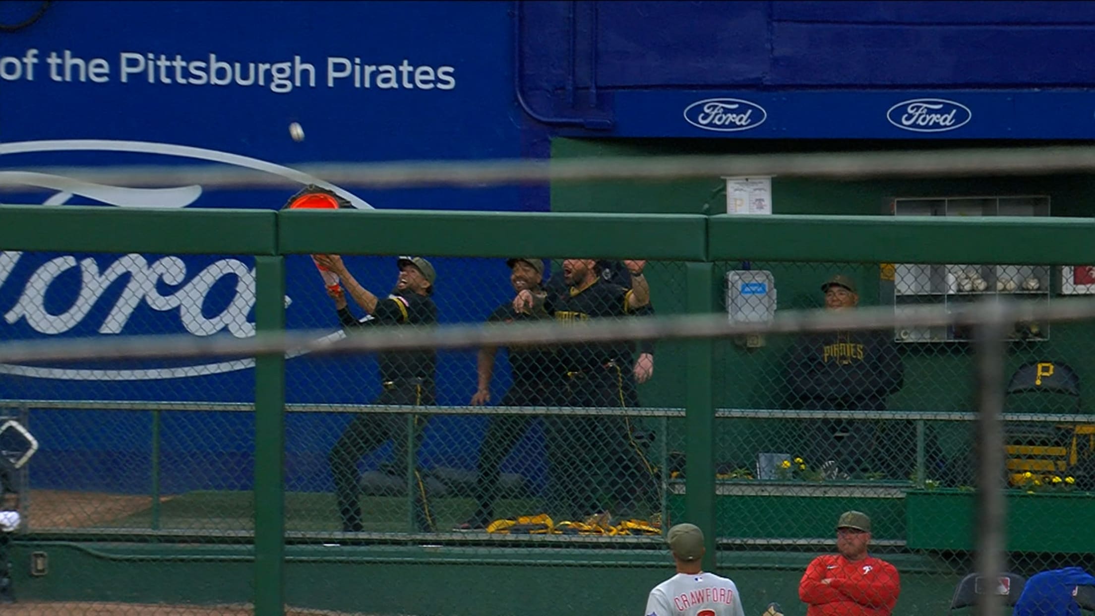 A Pirates reliever in the bullpen prepares to catch a ball in a traffic cone