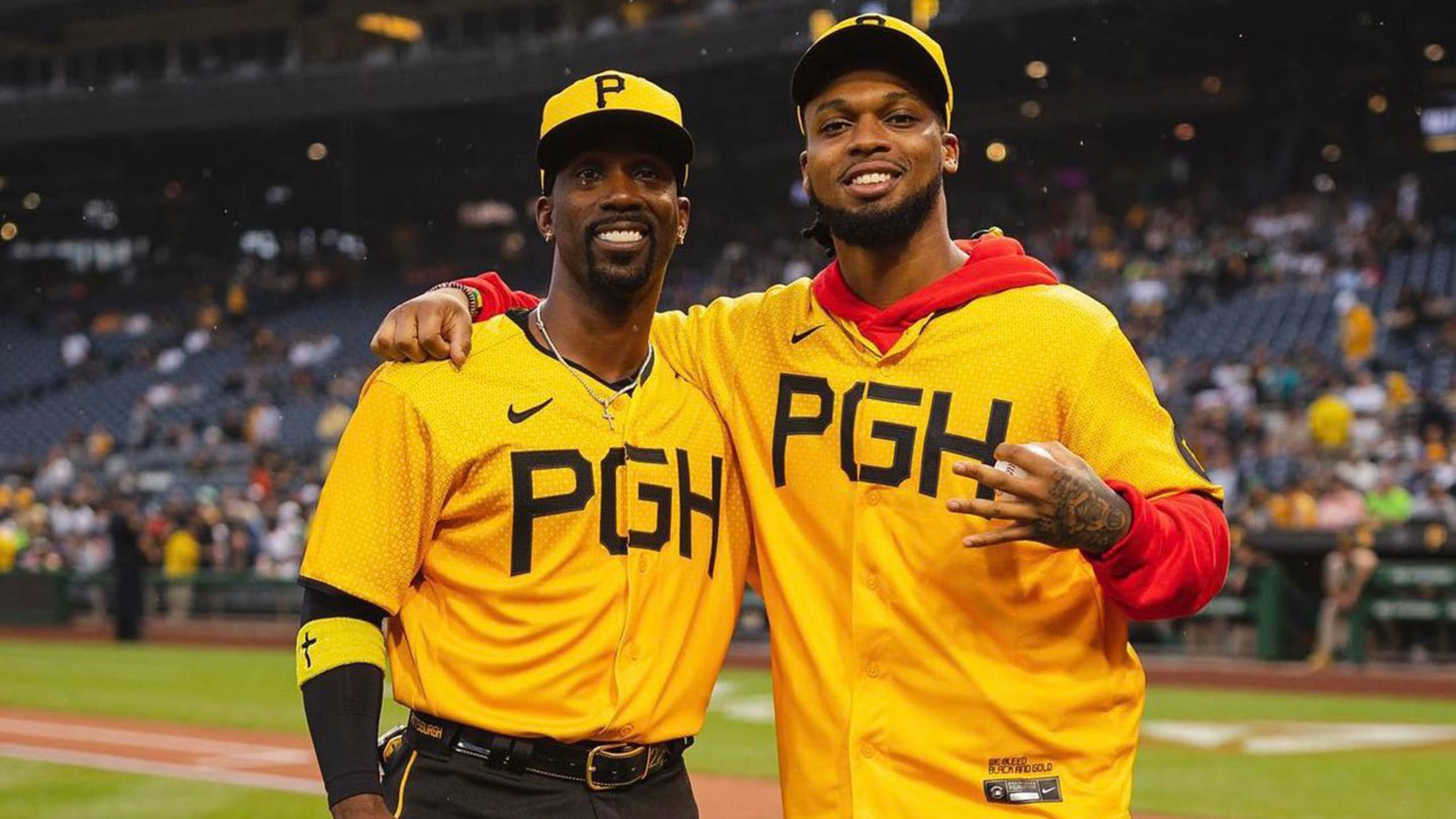 Andrew McCutchen and Damar Hamlin pose for a photo on the field