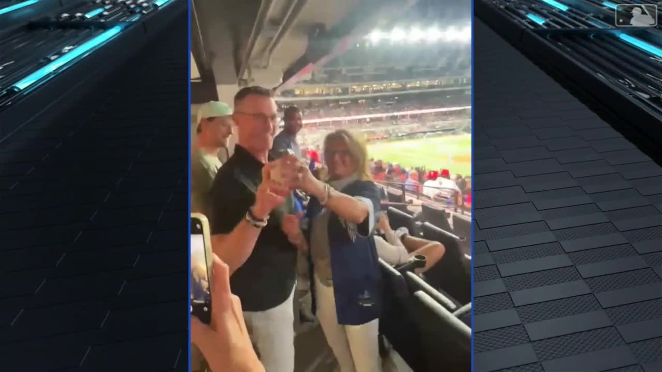 A video screengrab of Bobby Witt Jr.'s parents holding a baseball