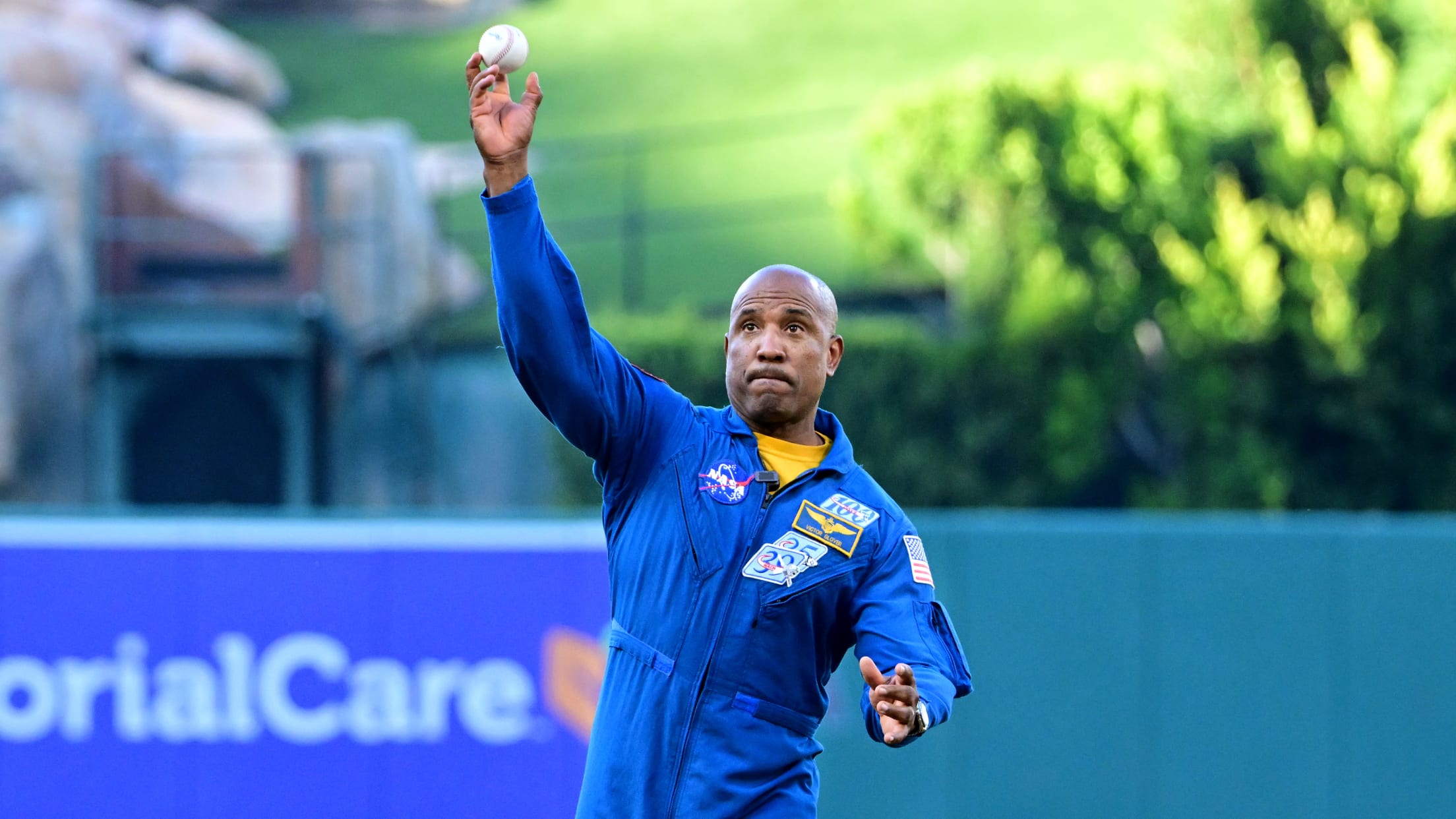 Artemis II astronaut Victor Glover Jr. throws a ceremonial first pitch