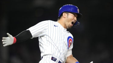 The Chicago Cubs' Seiya Suzuki (R) is congratulated by first base coach  Mike Napoli after hitting an RBI single in the fourth inning of a baseball  game against the Pittsburgh Pirates on