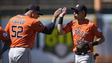 Houston Astros' Mauricio Dubon looks at his bat as he waits to hit