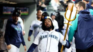 Seattle Mariners' Teoscar Hernandez holds a trident in the dugout after  hitting a solo home run Kansas City Royals during the second inning of a  baseball game, Sunday, Aug. 27, 2023, in