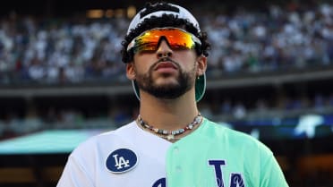 Rapper and singer Bad Bunny runs in the outfield during the MLB
