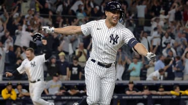 The New York Yankees celebrate after Giancarlo Stanton hit a grand slam  home run in the 9th inning to give the Yankees a 9-8 victory over the  Pittsburgh Pirates at Yankee Stadium