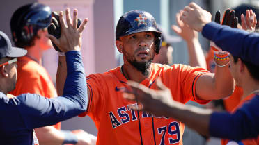 Houston Astros' Jose Abreu, center, has fun. In the dugout before