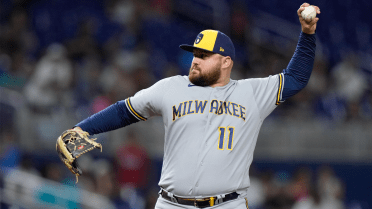 Milwaukee Brewers' Rowdy Tellez sits in the dugout during a