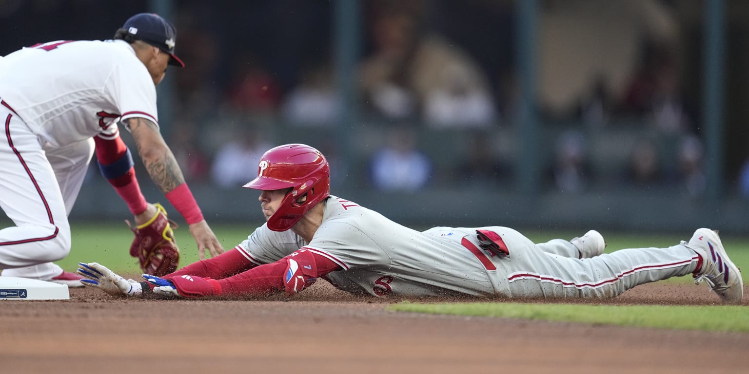 Miami Marlins' Jean Segura runs to beat the throw by Philadelphia Phillies  second baseman Bryson Stott but is out at the plate during the eighth  inning of a baseball game, Sunday, July