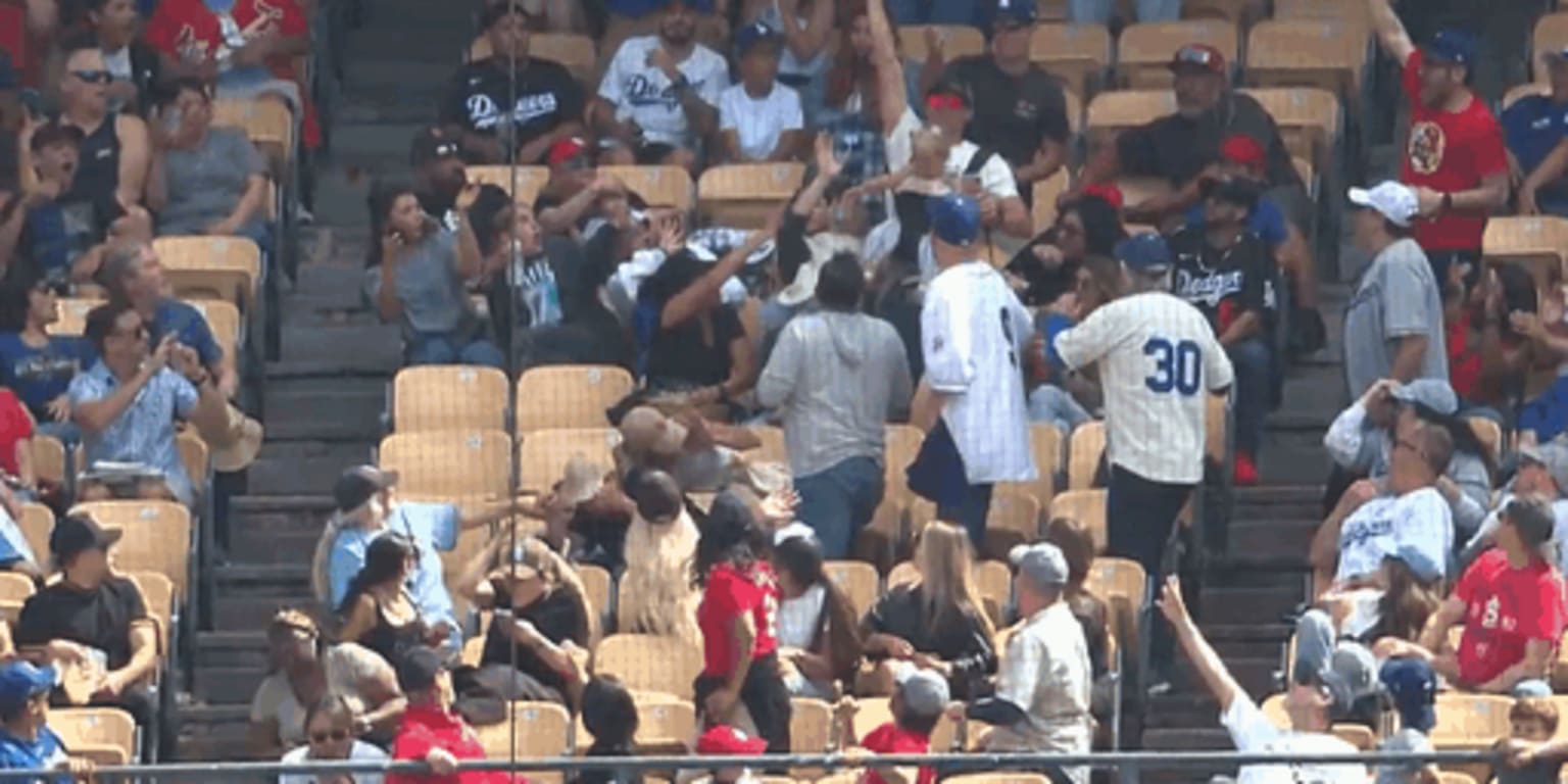 Baby-wearing, beverage-holding man catches foul ball with bare