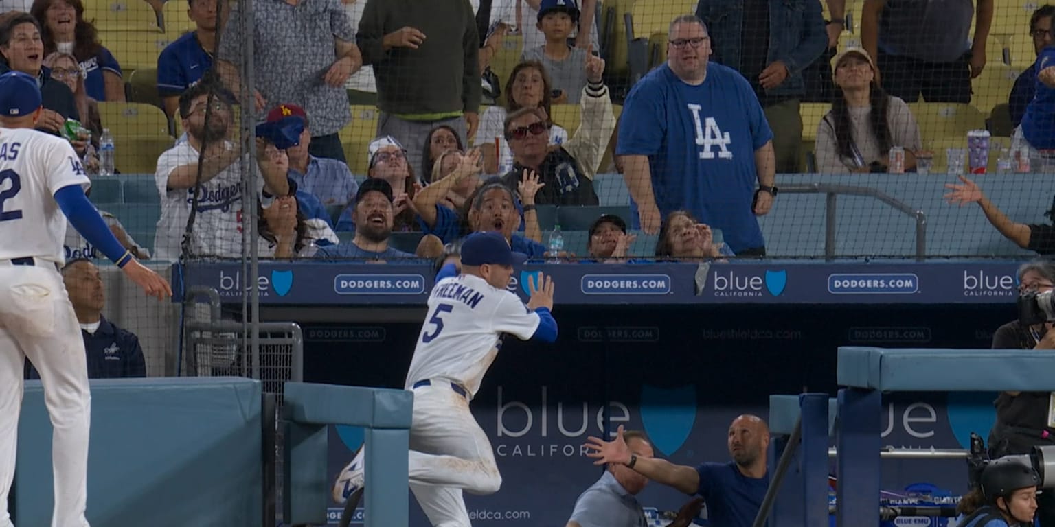 Freeman takes scary tumble into opposing dugout, exits later