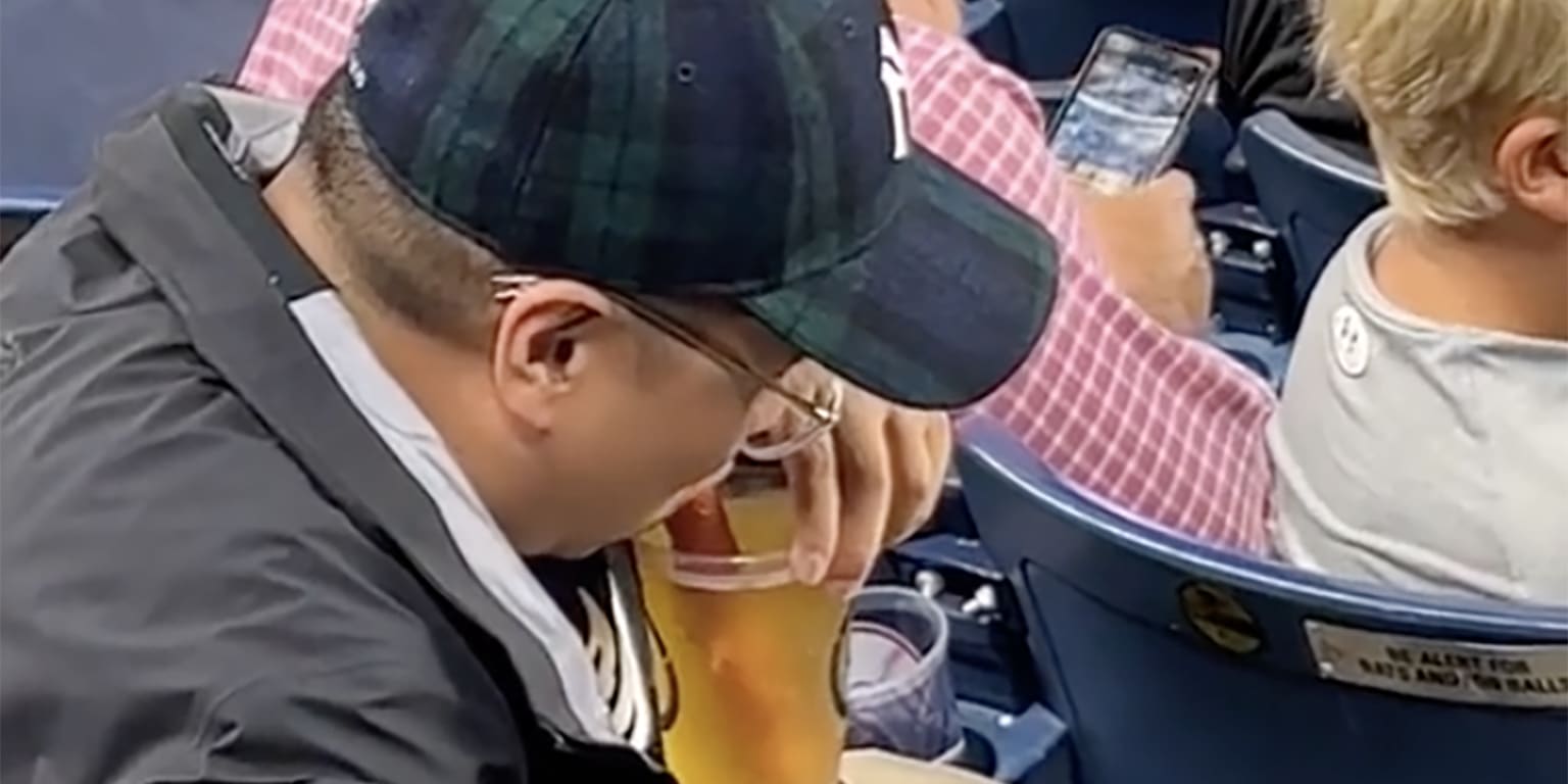 Yankees fan drinks beer through a hot dog straw