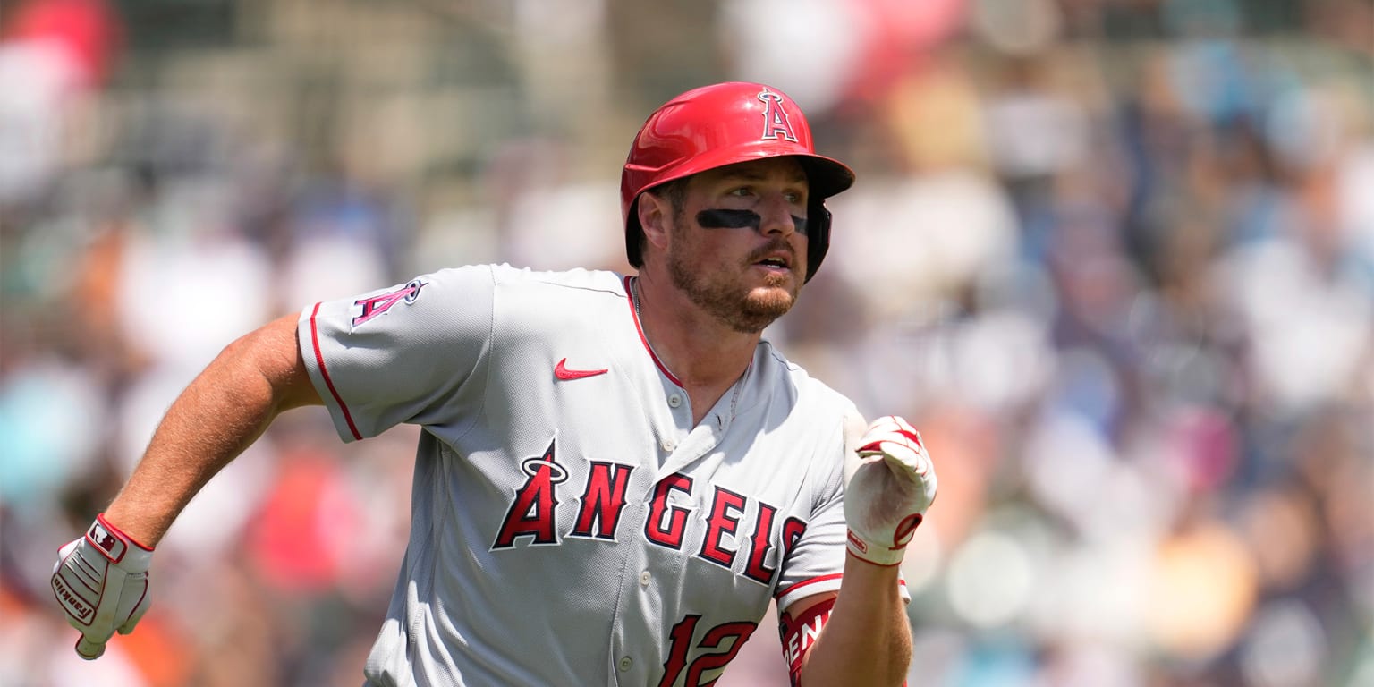 Los Angeles Angels' Mike Trout (27) gives Hunter Renfroe (12) a helmet  after Renfroe hit a home run during the eighth inning of a baseball game  against the Toronto Blue Jays in