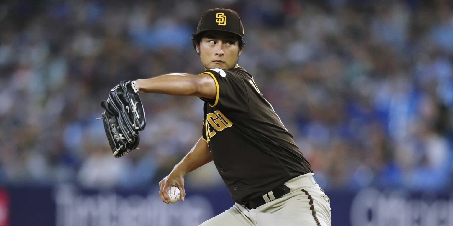 San Diego Padres starting pitcher Yu Darvish, left, leaves the