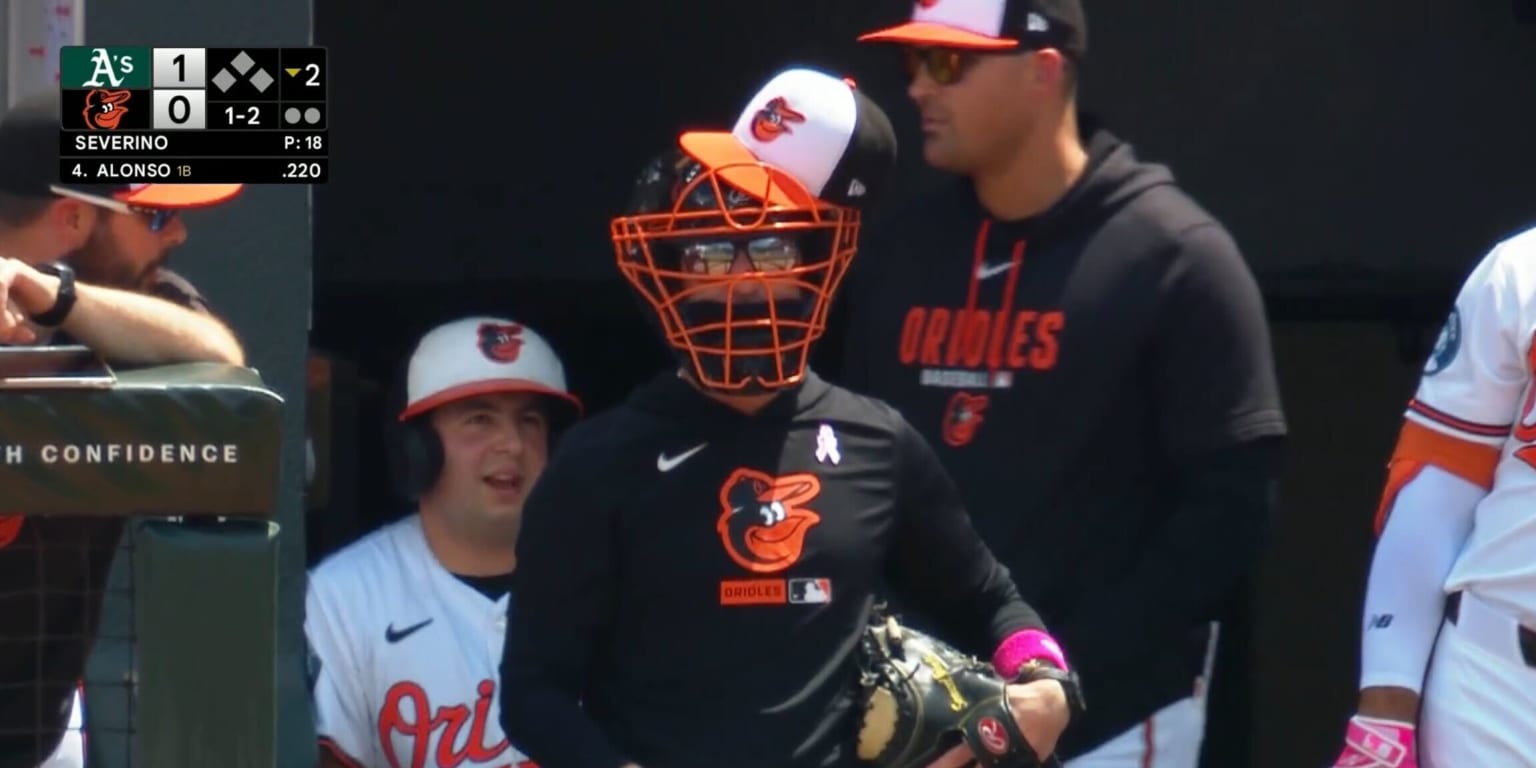 Why is this manager wearing catcher's gear in the dugout?