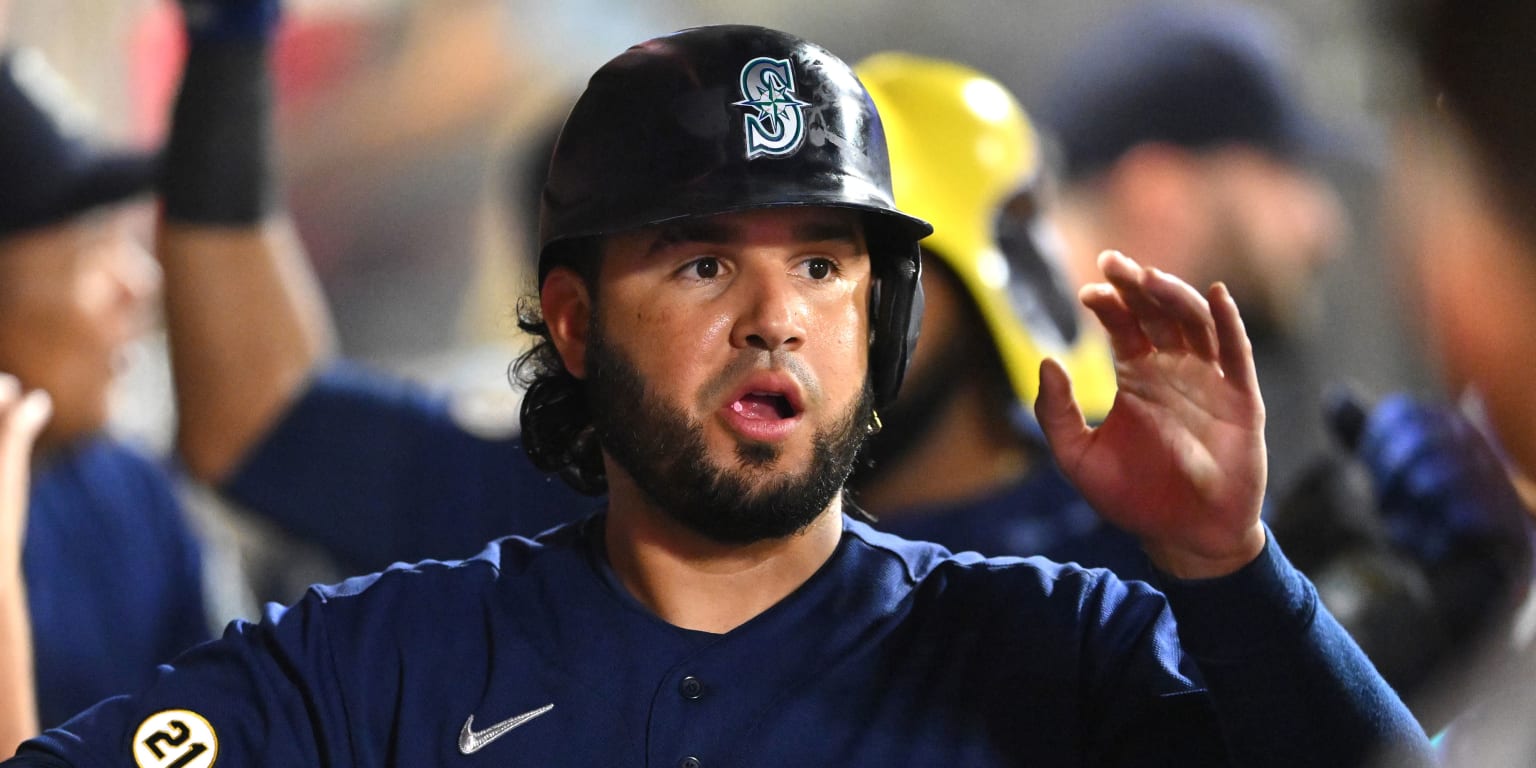 Seattle Mariners' Eugenio Suarez makes a heart shape after hitting