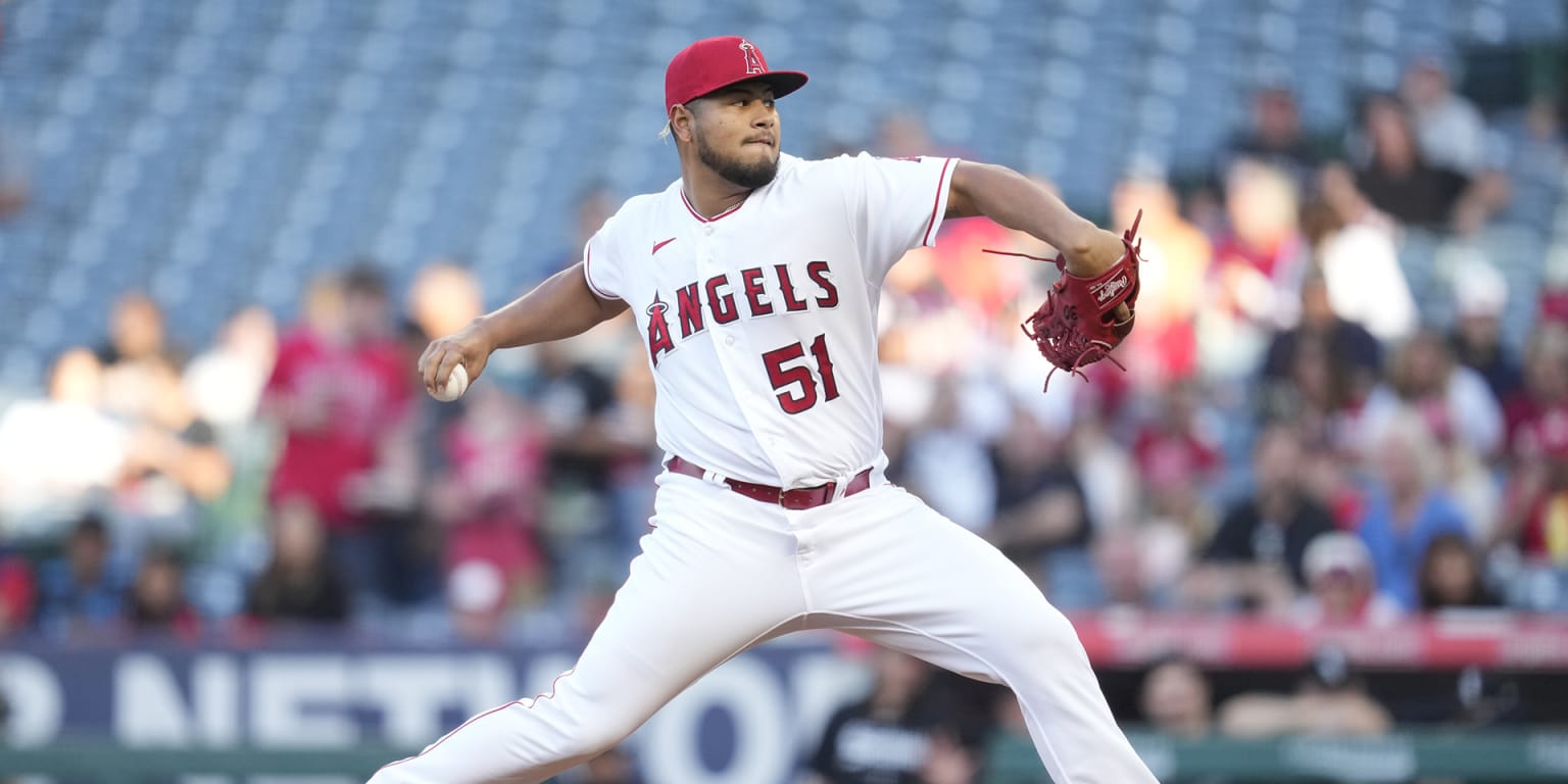 Los Angeles Angels pitcher Jaime Barria, right, sits in the dugout