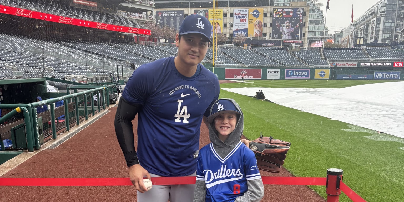 Young fan watches workout in the downpour, gets rewarded by Ohtani himself