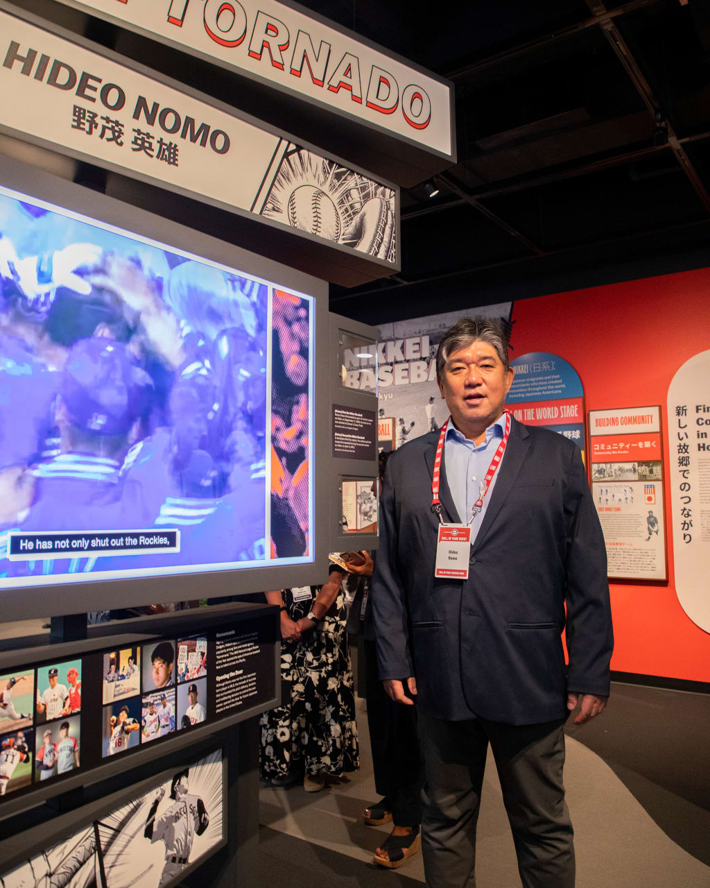 Hideo Nomo stands at a display spotlighting his career accomplishments in "Yakyu | Baseball: The Transpacific Exchange of the Game." (Milo Stewart Jr./National Baseball Hall of Fame and Museum)