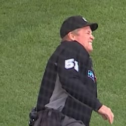 Home plate umpire Marvin Hudson warns New York Yankees manager Joe