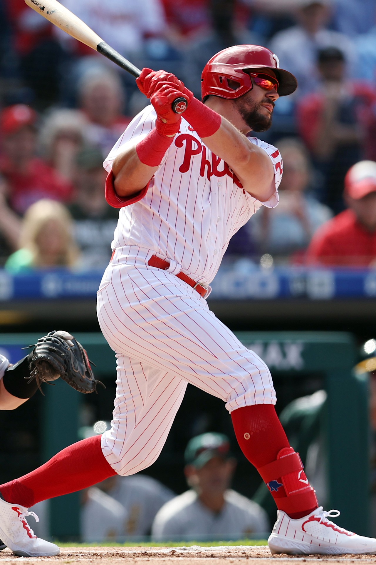 Philadelphia Phillies slugger Kyle Schwarber swinging at the plate, the headline bat in tonight's Field of Dreams game against the Twins in Dyersville, Iowa