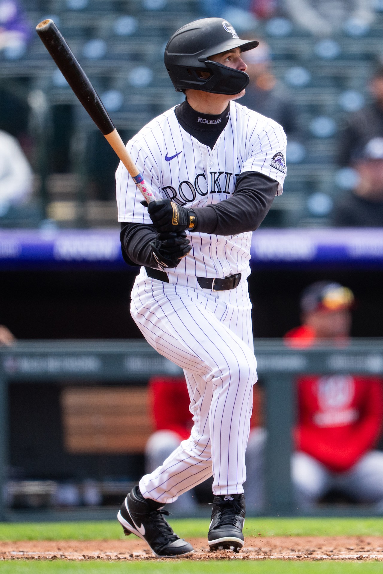 Colorado Rockies outfielder Mickey Moniak taking a swing, one of the Rockies hitters facing the Dodgers at Coors Field on August 18