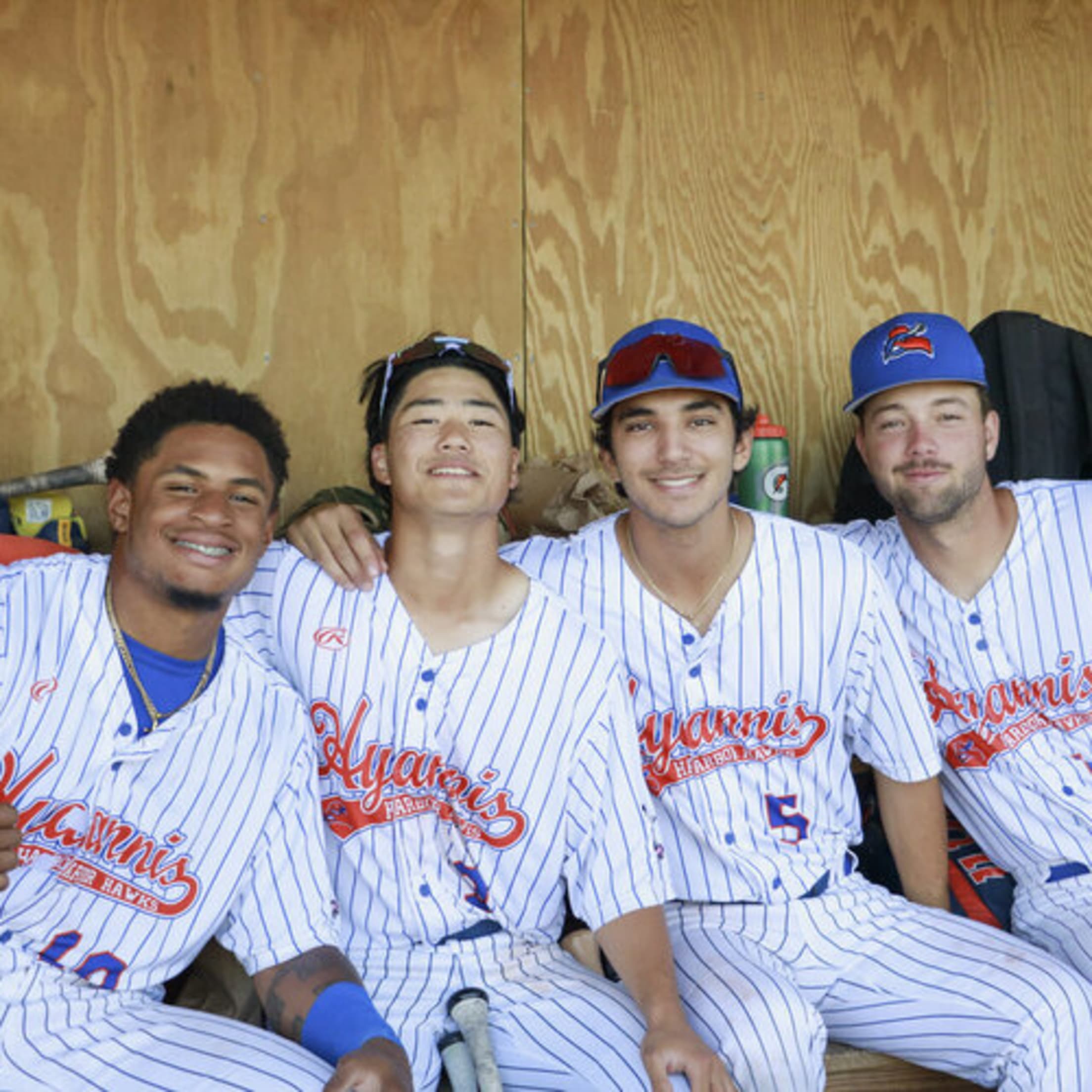 Players smile together in the home dugout in Hyannis.