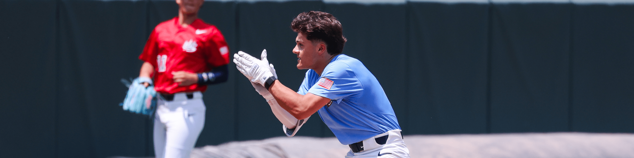 Baseball player wearing blue clapping hands